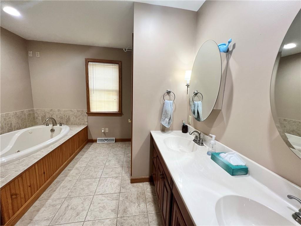 2045 Eastbrook Road New Castle, PA 16101 - Photo 13 of 23 a bathroom with a tub sink and mirror