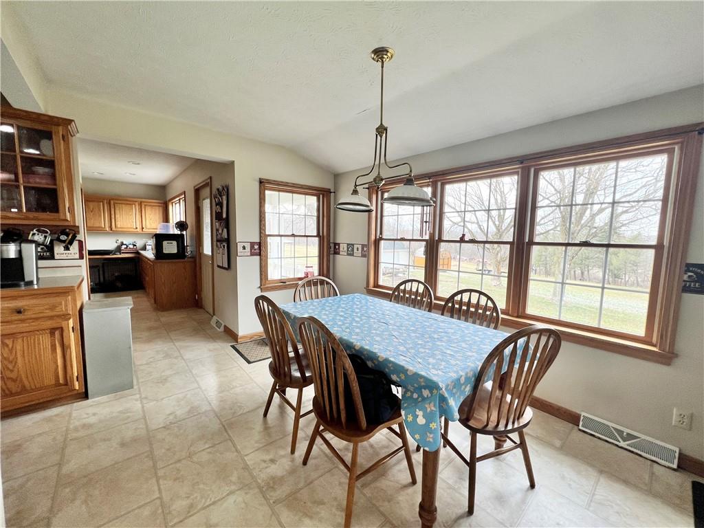 2045 Eastbrook Road New Castle, PA 16101 - Photo 9 of 23 a view of a dining room and livingroom with furniture wooden floor a chandelier