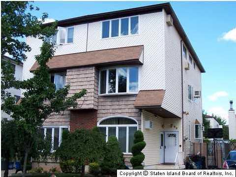 83 Green Valley Road Staten Island, NY 10312 - Photo 1 of 3 a front view of a house with a garden
