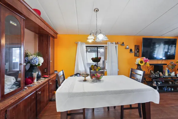 a view of a dining room with furniture and chandelier