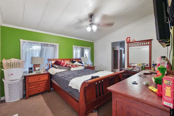 a bedroom with a bed and a chandelier