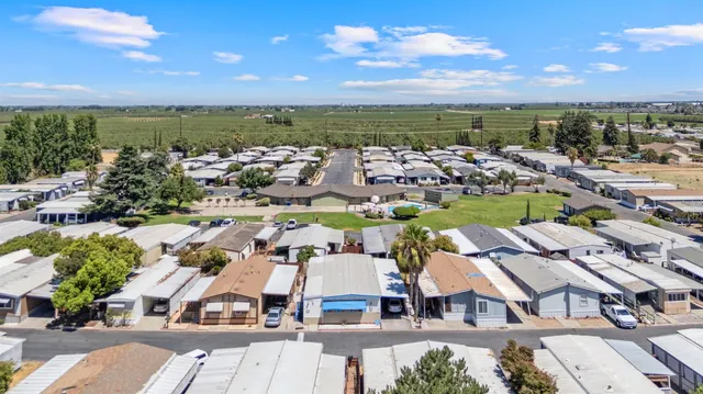 an aerial view of residential houses with outdoor space and ocean view