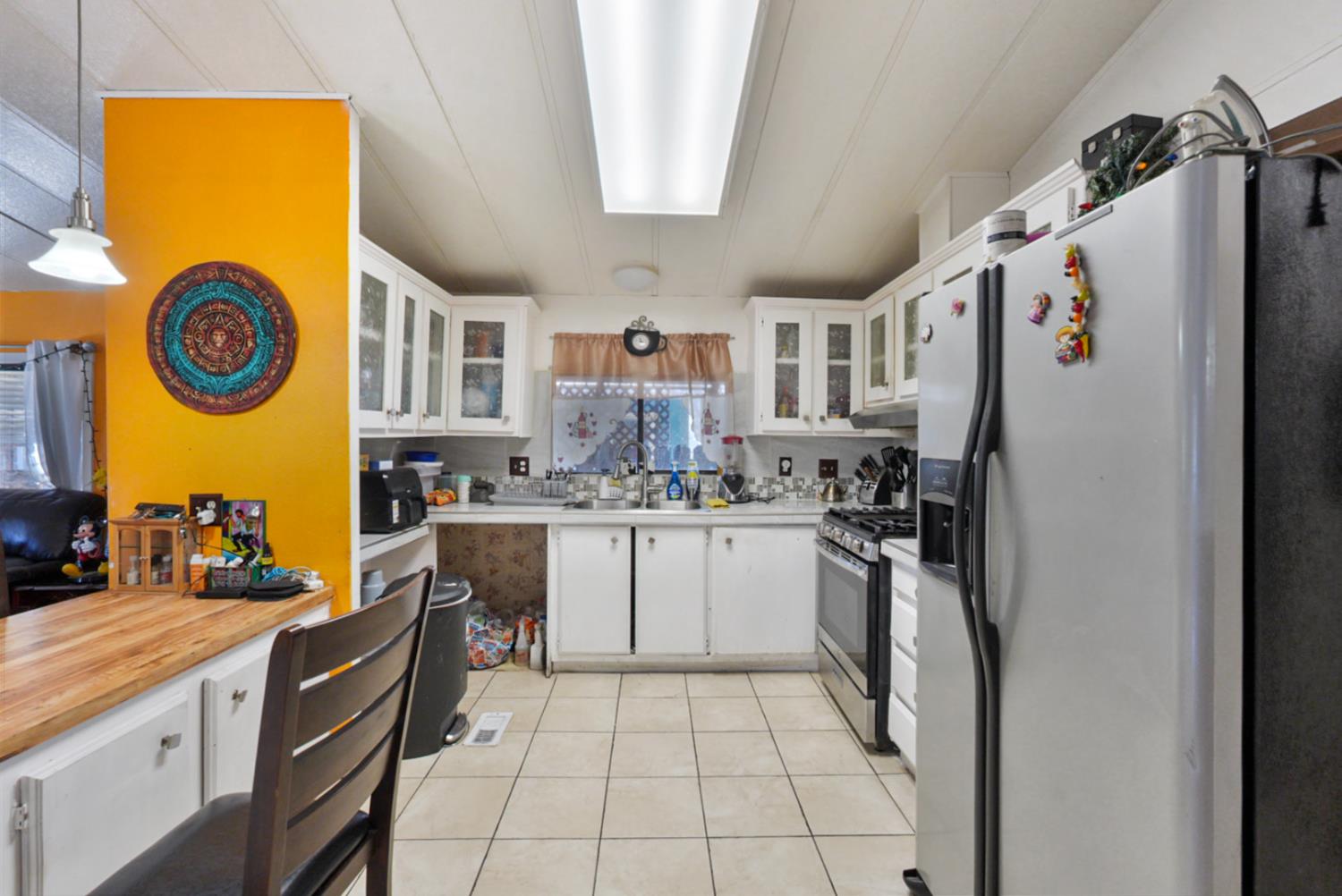 4837 Faith Home Road, Unit 102 Ceres, CA 95307 - Photo 8 of 16 a kitchen with stainless steel appliances granite countertop a refrigerator and a stove top oven
