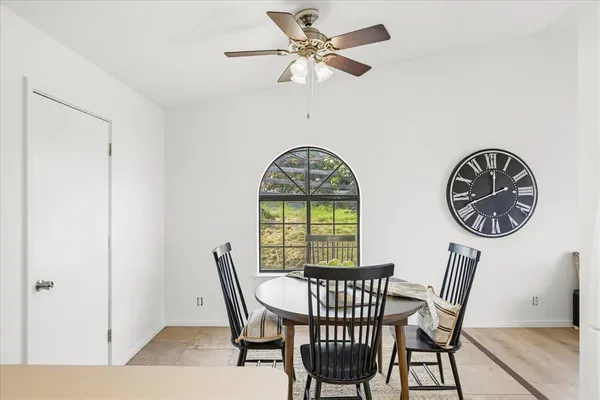 a view of a dining room with furniture and a window