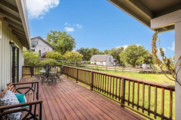 a view of balcony with chairs and wooden floor
