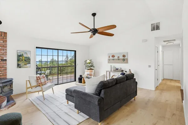a living room with furniture a ceiling fan and a window