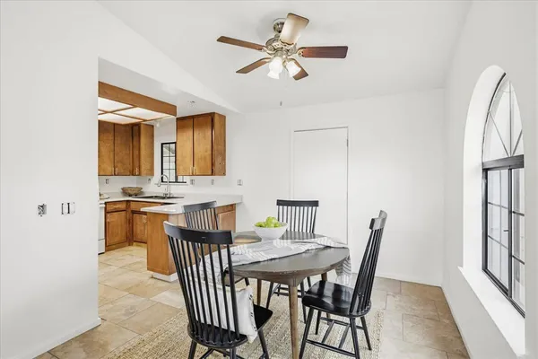 a view of a dining room with furniture and a kitchen