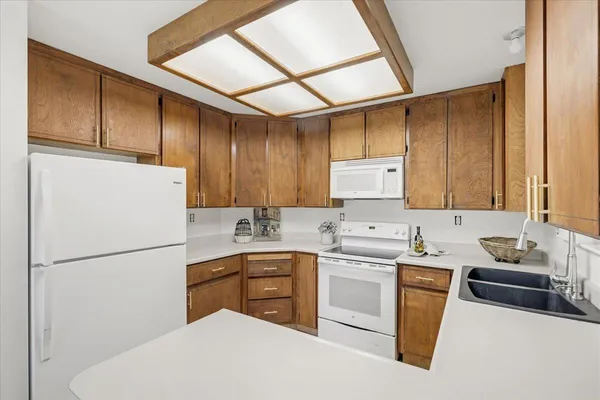 a kitchen with a sink a refrigerator and cabinets