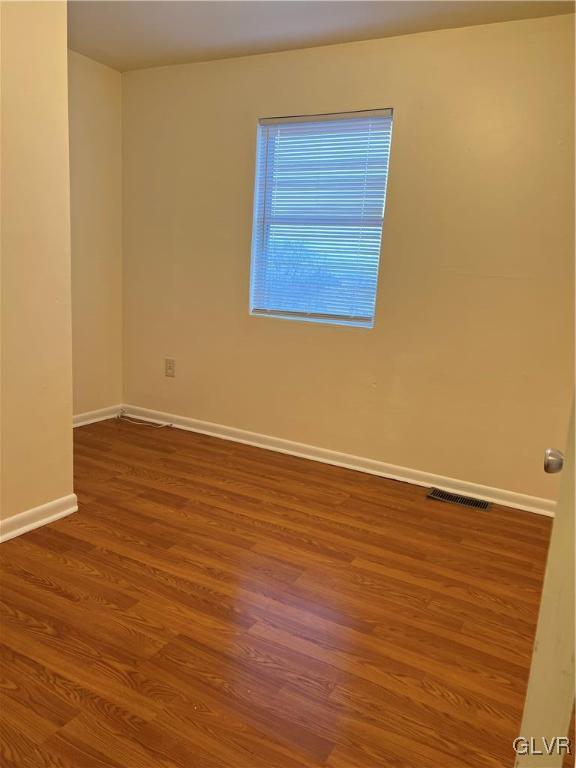 1538 East 8th Street, Unit C Bethlehem, PA 18015 - Photo 16 of 18 a view of an empty room with wooden floor and a window
