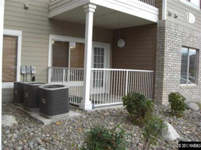 a view of a house with a large window and wooden fence