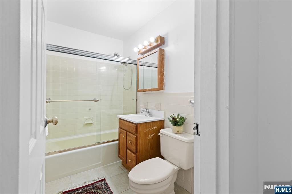 6 Colonial Drive, Unit 6A Little Falls, NJ 07424 - Photo 18 of 44 a bathroom with a sink a toilet a mirror and shower