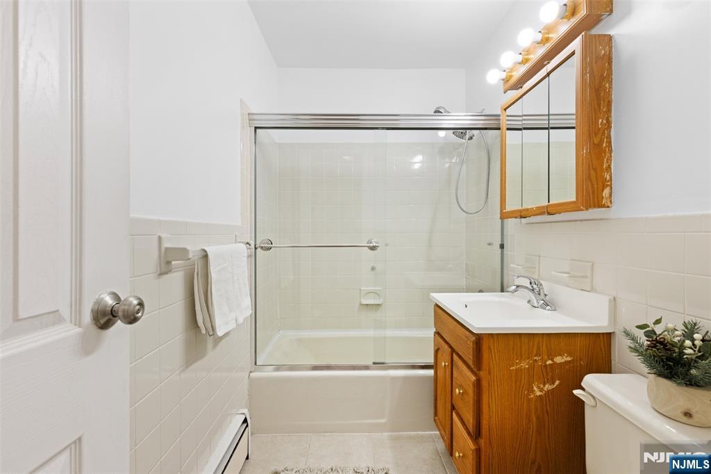 6 Colonial Drive, Unit 6A Little Falls, NJ 07424 - Photo 19 of 44 a bathroom with a sink vanity mirror and shower