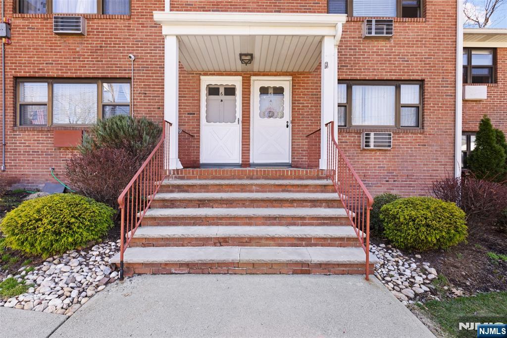 6 Colonial Drive, Unit 6A Little Falls, NJ 07424 - Photo 26 of 44 a front view of a house with a garden