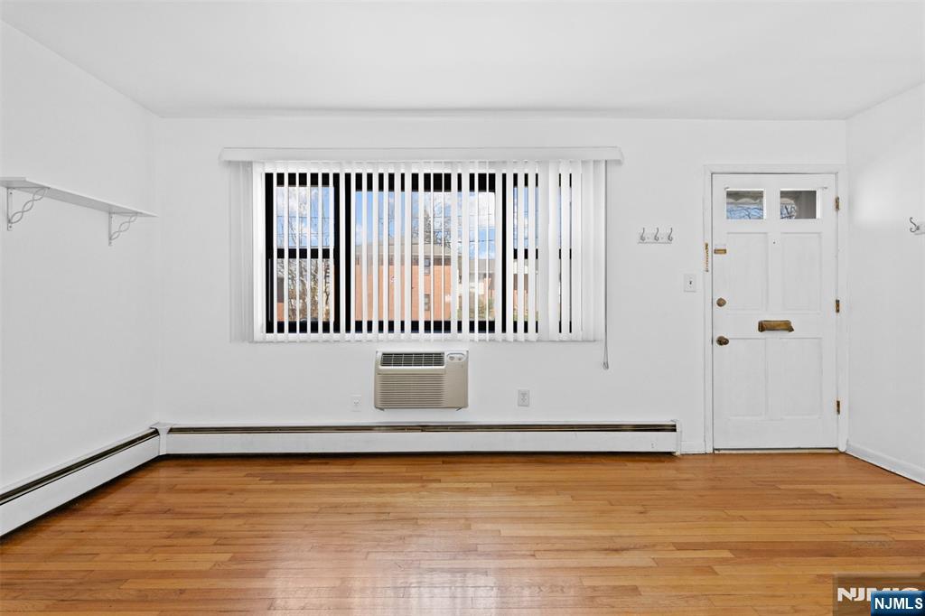 6 Colonial Drive, Unit 6A Little Falls, NJ 07424 - Photo 5 of 44 a view of a room with wooden floor and a window