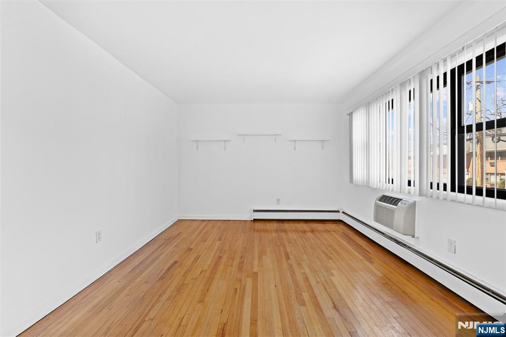 6 Colonial Drive, Unit 6A Little Falls, NJ 07424 - Photo 6 of 44 a view of a room with wooden floor and staircase