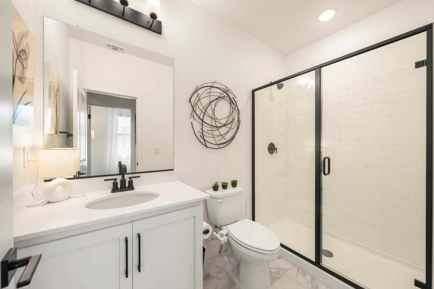 4216 Creede Way Rancho Cordova, CA 95742 - Photo 37 of 56 a bathroom with a toilet a sink and a mirror