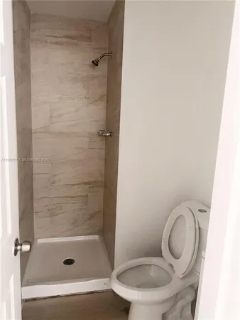 a bathroom with a toilet and a shower