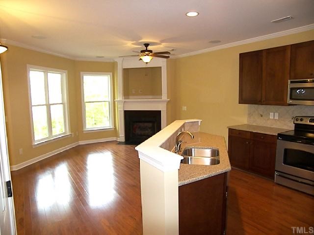 3507 Provost Street Raleigh, NC 27603 - Photo 3 of 12 Austen kitchen/family room pictures are from model. Custom mantel and fireplace, smooth 9' ceilings ? are std. Upgrades: hdwds, crown molding, stainless appliances, quartz counter tops, bronze fixtures, tile backsplash, and refrigerator.