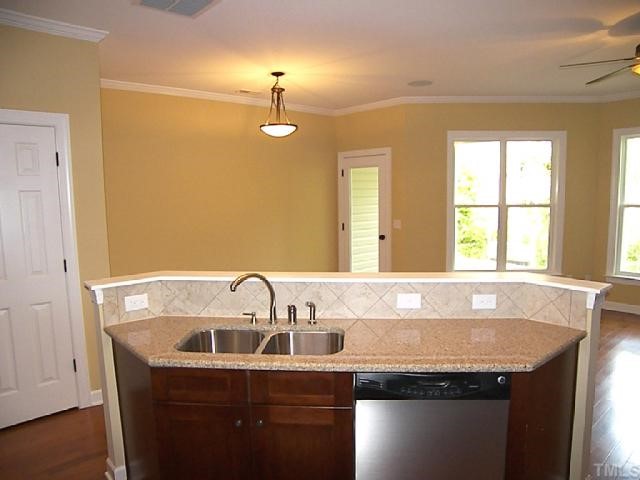 3507 Provost Street Raleigh, NC 27603 - Photo 5 of 12 Austen kitchen/dining pictures are from model. Custom mantel and fireplace, smooth 9' ceilings are std. Upgrades: hdwds, crown molding, stainless appliances, quartz counter tops, bronze fixtures, tile backsplash, and refrigerator.