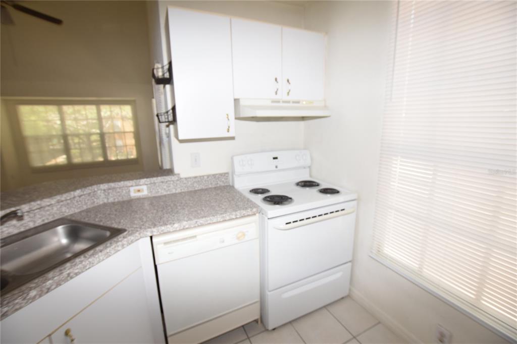 6324 Raleigh Street, Unit 714 Orlando, FL 32835 - Photo 16 of 32 a view of washer and dryer in a kitchen