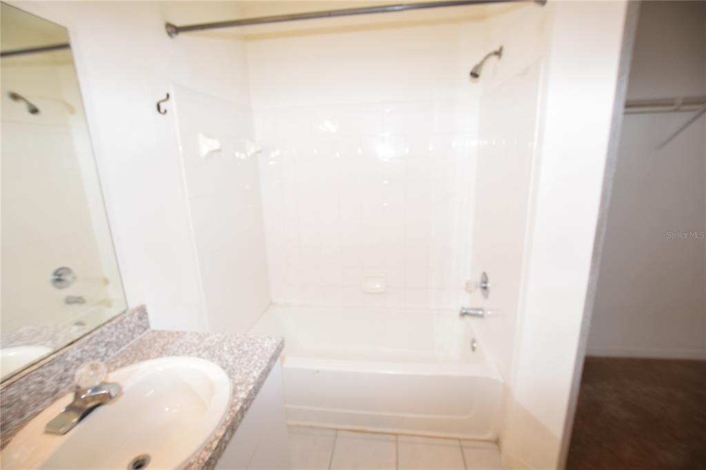 6324 Raleigh Street, Unit 714 Orlando, FL 32835 - Photo 30 of 32 a bathroom with a bathtub and shower