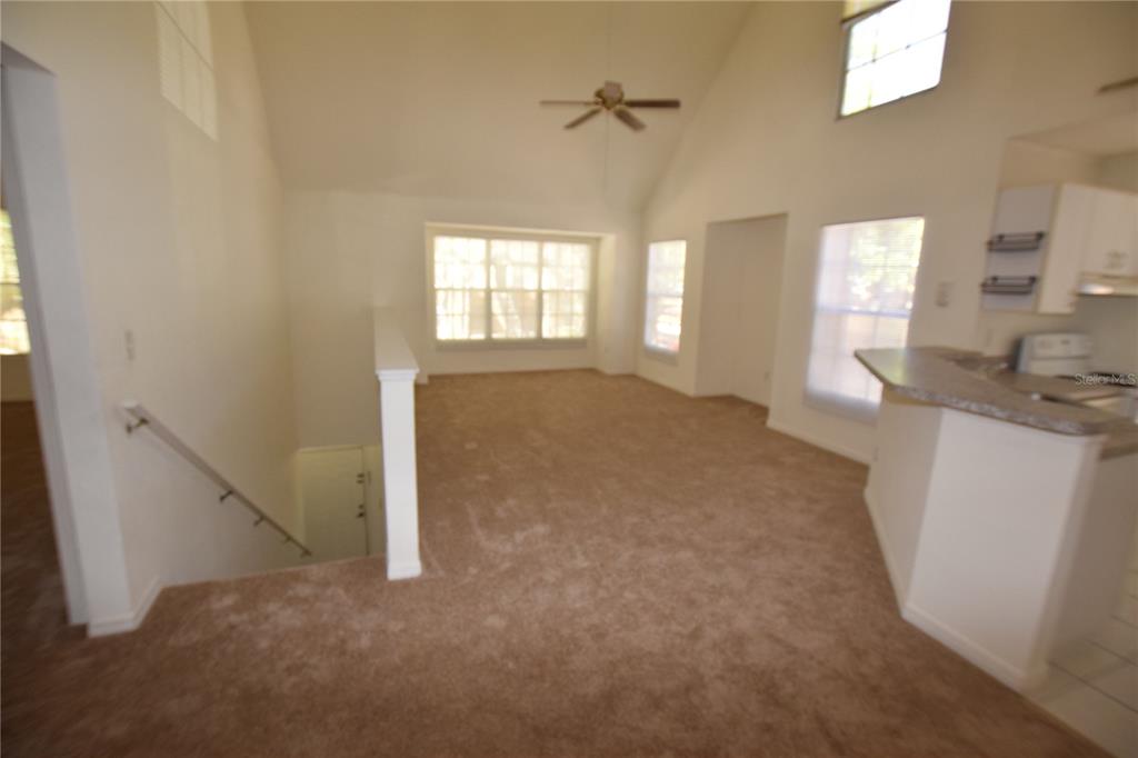 6324 Raleigh Street, Unit 714 Orlando, FL 32835 - Photo 4 of 32 a view of livingroom with hardwood floor and window
