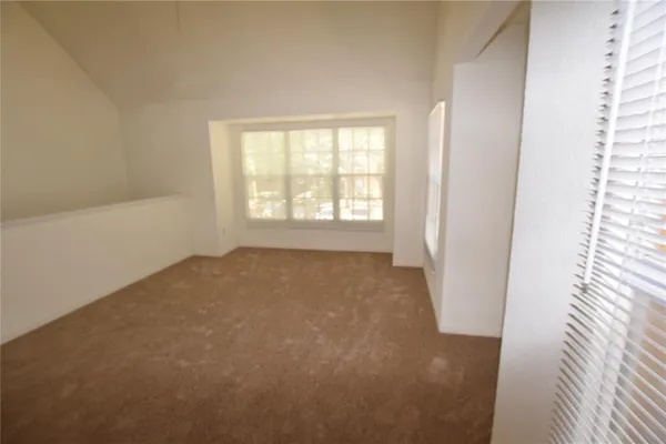 a view of an empty room and a window