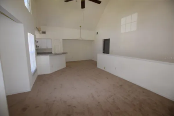 a view of a kitchen with a sink and dishwasher and a refrigerator