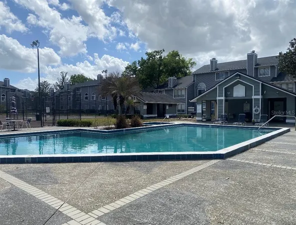 a view of a house with a swimming pool and a yard