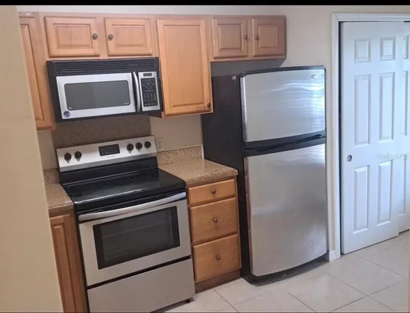 a kitchen with a stove microwave and refrigerator