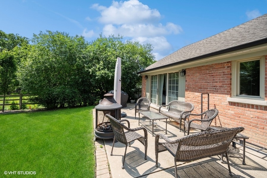 1165 West Deerpath Road Lake Forest, IL 60045 - Photo 15 of 16 a view of a patio with table and chairs and potted plants