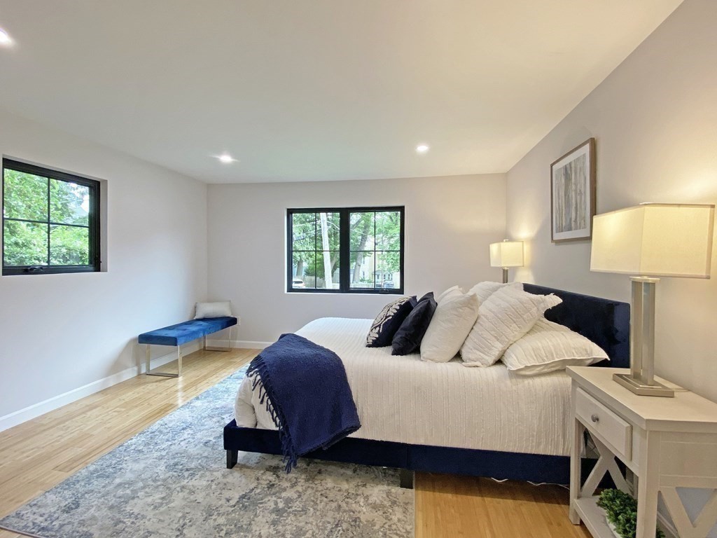 9 Glazer Road, Unit 9 Newton, MA 02459 - Photo 17 of 40 a bedroom with a bed and a lamp