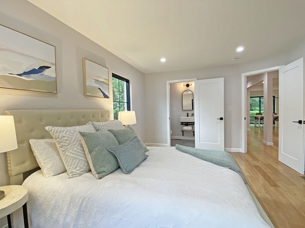 9 Glazer Road, Unit 9 Newton, MA 02459 - Photo 23 of 40 a spacious bedroom with a bed and a large mirror