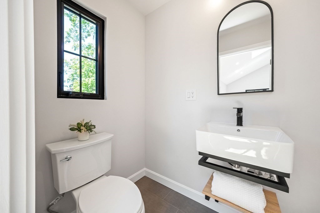 9 Glazer Road, Unit 9 Newton, MA 02459 - Photo 24 of 40 a white toilet sitting next to a bathroom sink