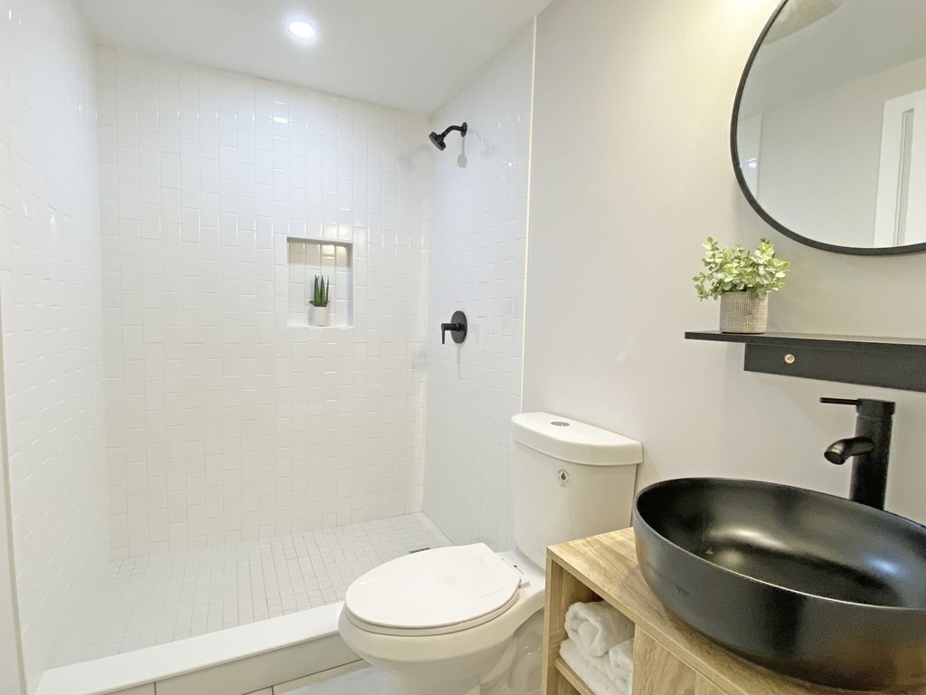9 Glazer Road, Unit 9 Newton, MA 02459 - Photo 29 of 40 a bathroom with a toilet and a sink