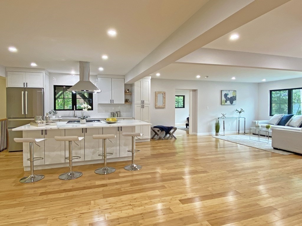 9 Glazer Road, Unit 9 Newton, MA 02459 - Photo 3 of 40 a large room with stainless steel appliances lots of white furniture a swimming pool and couches
