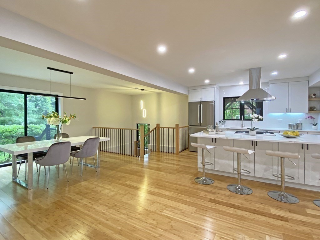 9 Glazer Road, Unit 9 Newton, MA 02459 - Photo 6 of 40 a large dining hall with stainless steel appliances granite countertop a couch dining table chairs and a large window
