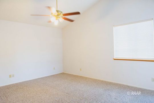 1116 Lee Avenue Ridgecrest, CA 93555 - Photo 14 of 32 an empty room with a ceiling fan and a window