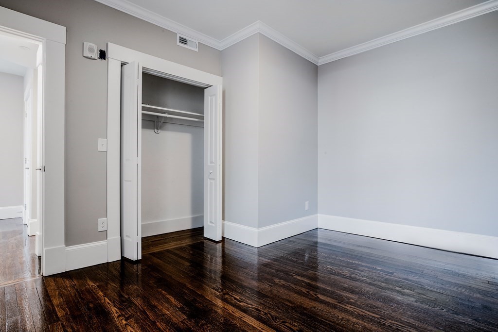 59 Strathmore Road, Unit 2 Boston, MA 02135 - Photo 11 of 13 a view of empty room with wooden floor and window
