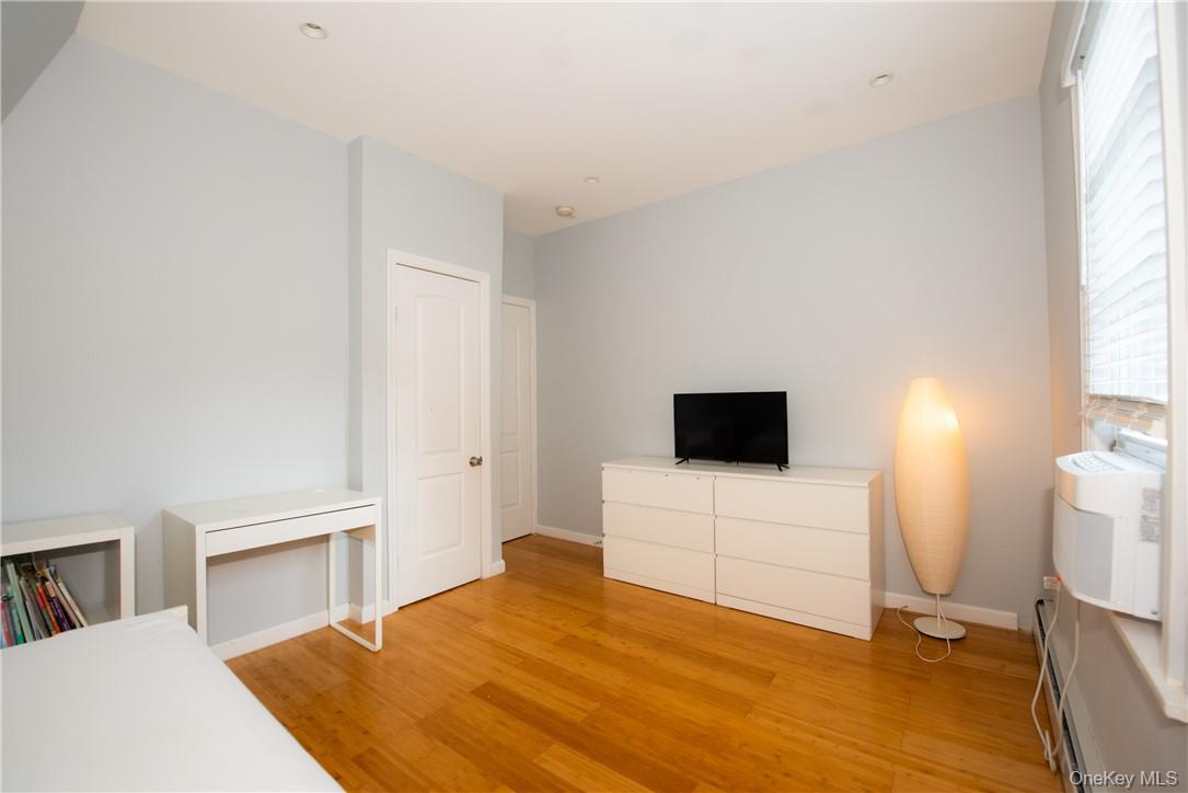 37 South Washington Avenue Hartsdale, NY 10530 - Photo 11 of 34 a bedroom with a bed and a flat screen tv