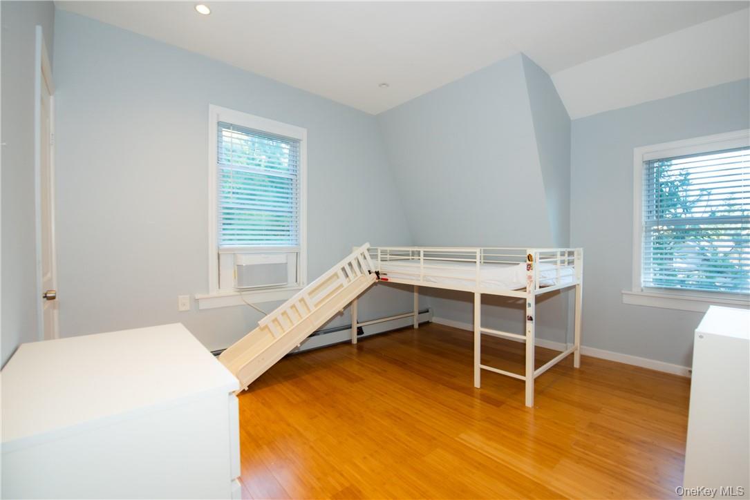 37 South Washington Avenue Hartsdale, NY 10530 - Photo 13 of 34 a bed room with a bed and a table