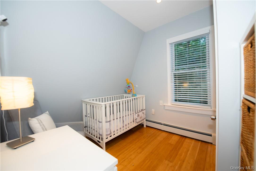 37 South Washington Avenue Hartsdale, NY 10530 - Photo 15 of 34 a bedroom with a bed and a window