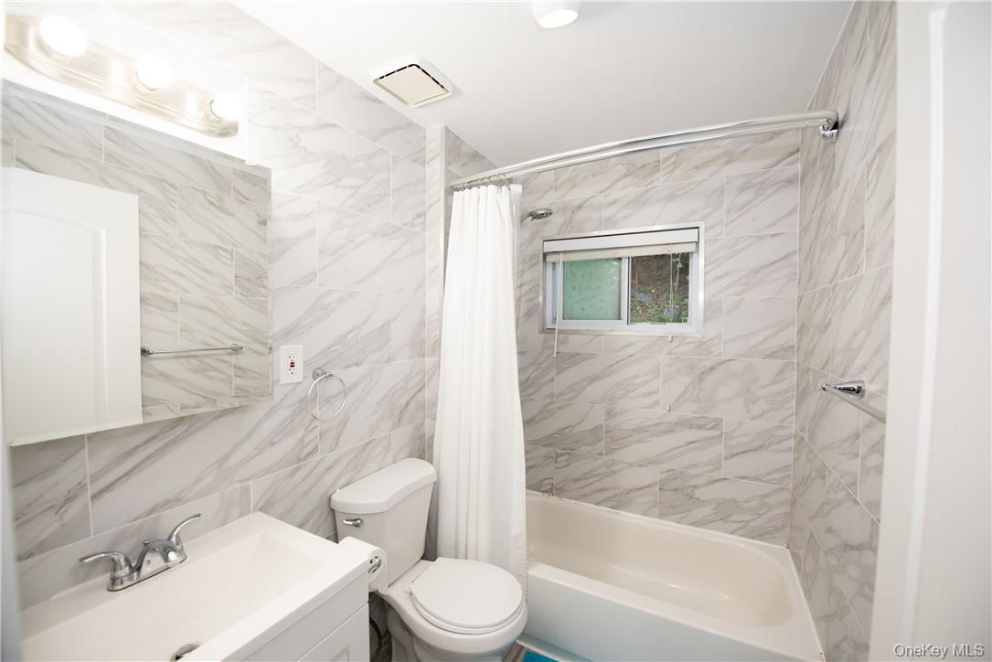 37 South Washington Avenue Hartsdale, NY 10530 - Photo 17 of 34 a bathroom with a toilet and a bathtub