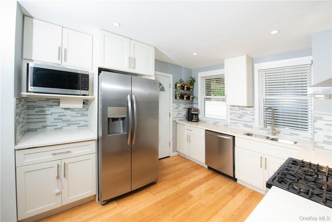 37 South Washington Avenue Hartsdale, NY 10530 - Photo 5 of 34 a kitchen with stainless steel appliances a refrigerator sink and microwave