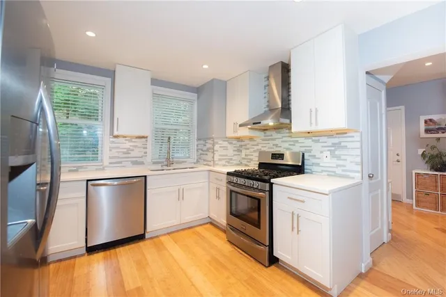 a kitchen with stainless steel appliances granite countertop a stove and a sink