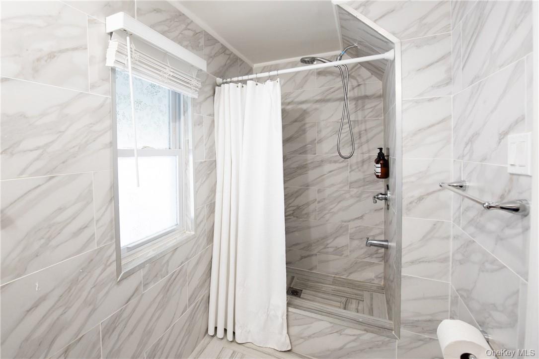 37 South Washington Avenue Hartsdale, NY 10530 - Photo 8 of 34 a bathroom with a glass door shower