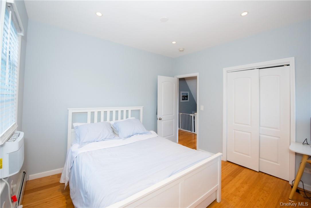 37 South Washington Avenue Hartsdale, NY 10530 - Photo 9 of 34 a bedroom with a bed and a lamp on the dresser