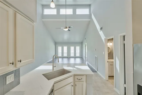 a view of a livingroom with a sink and dishwasher with kitchen view