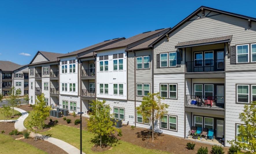 4000 Mill Spring Circle, Unit 4433 Oakwood, GA 30566 - Photo 13 of 28 a front view of a residential apartment building with a yard