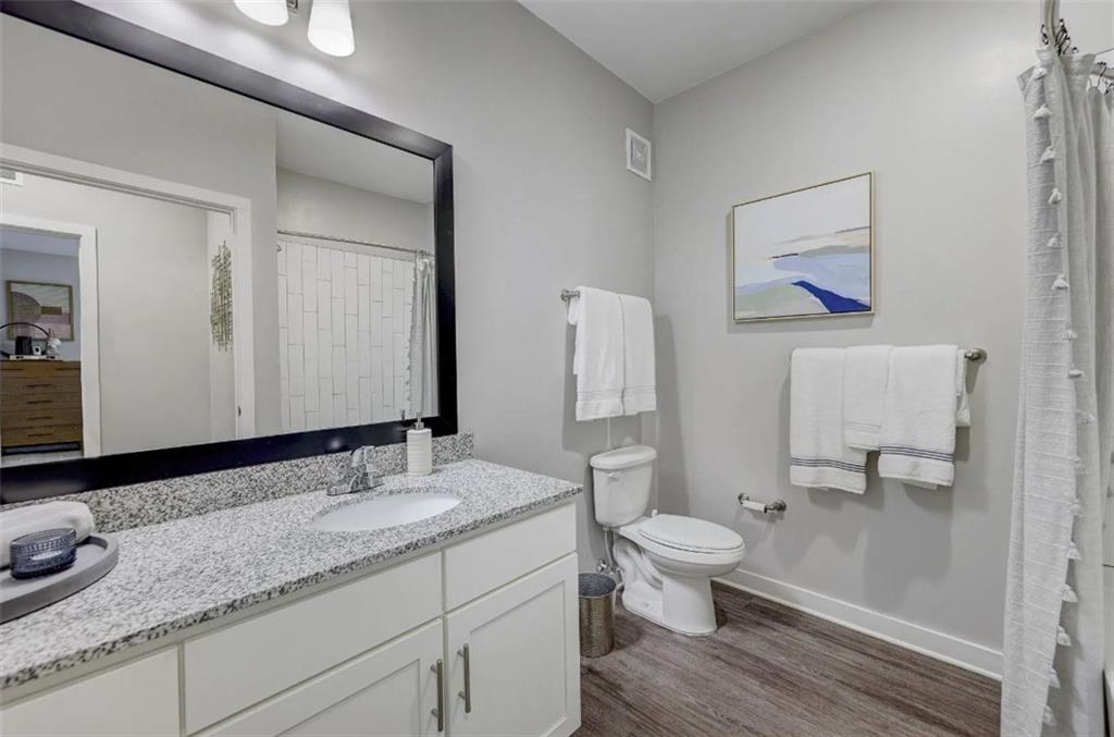 4000 Mill Spring Circle, Unit 4433 Oakwood, GA 30566 - Photo 8 of 28 a bathroom with a granite countertop sink mirror and toilet